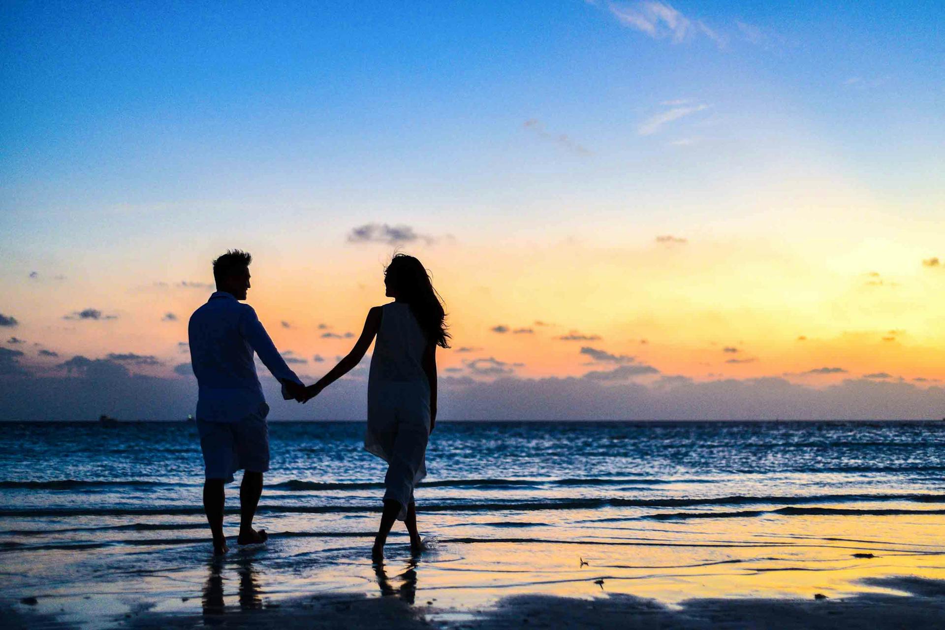 Romantic couple portrait near El Arco with golden Pacific light in Cabo San Lucas