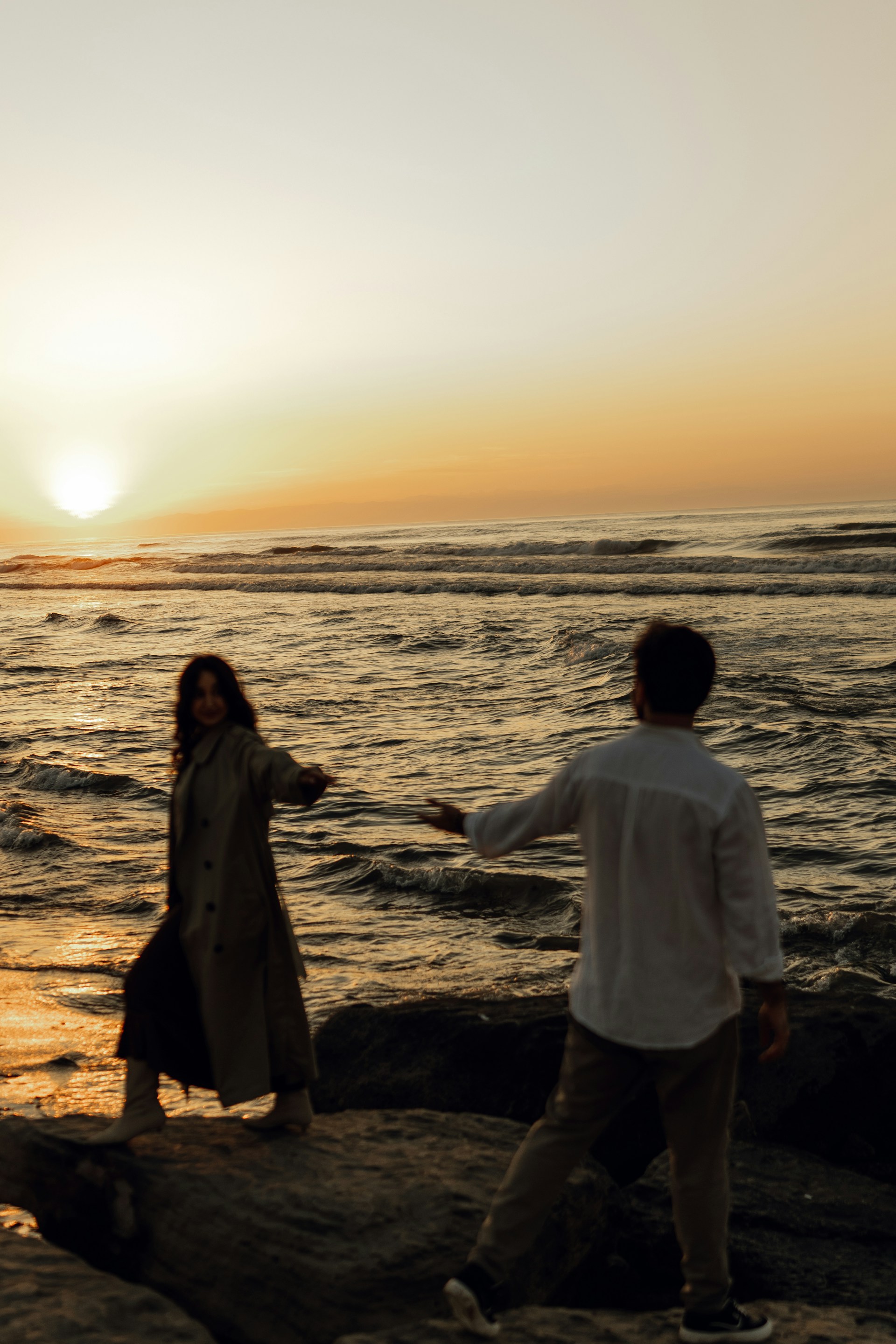Luxury couple portrait at sunset on the cliffs of Cabo San Lucas with the Pacific Ocean and El Arco in the background