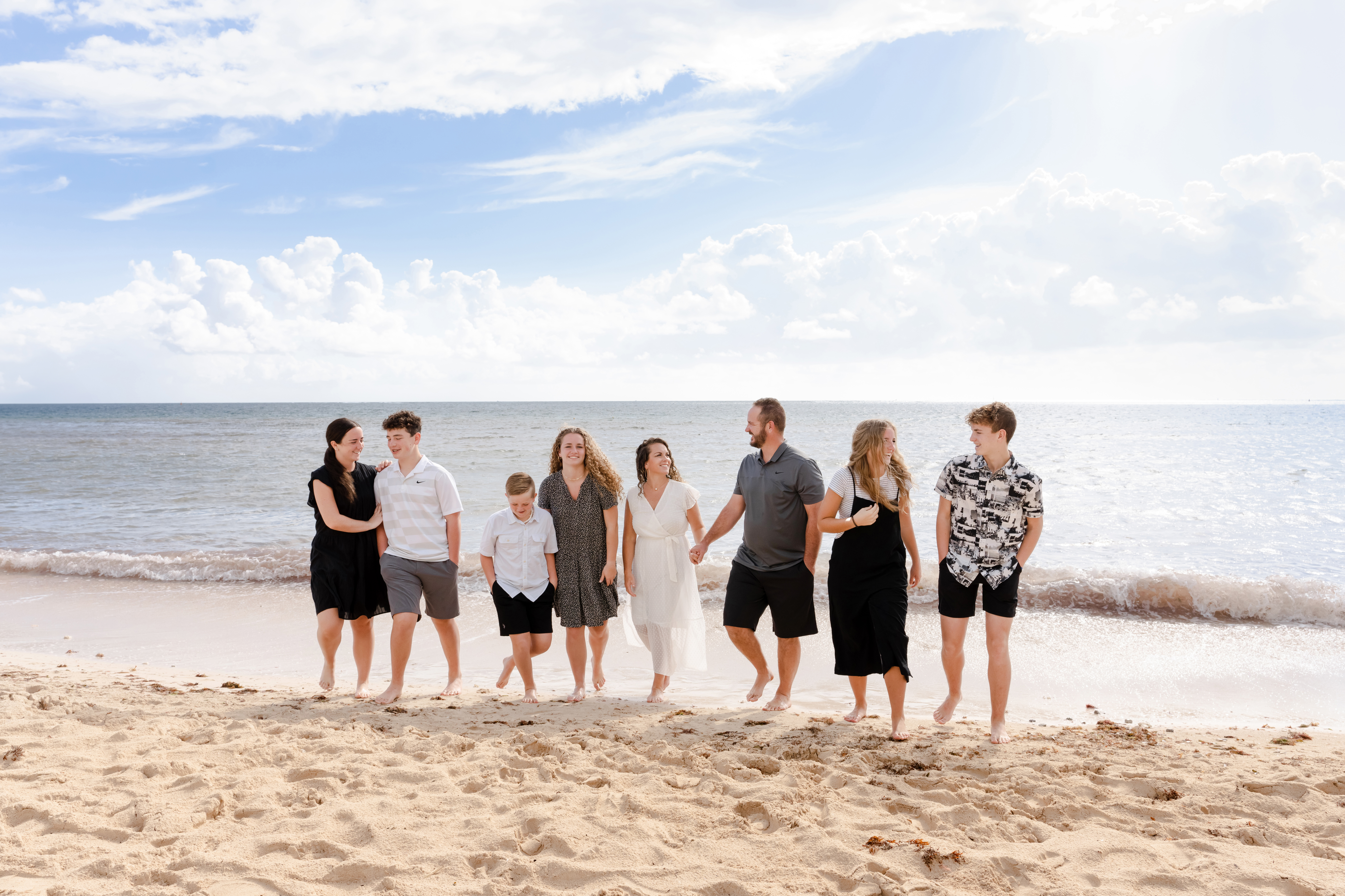 Extended family portrait on Cancun beach during golden hour by IVAE Studios