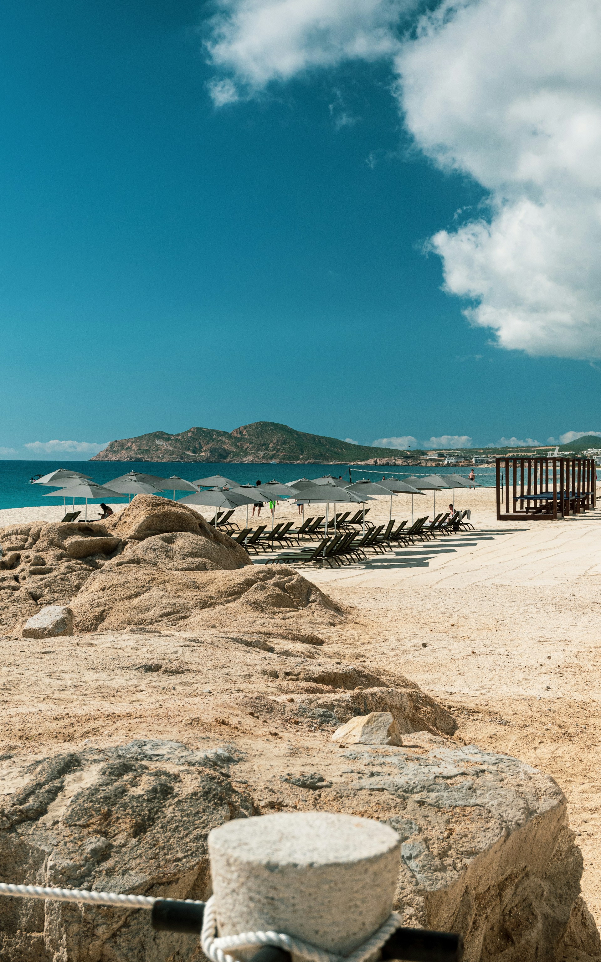 Golden sand of Medano Beach with luxury resorts in Cabo San Lucas