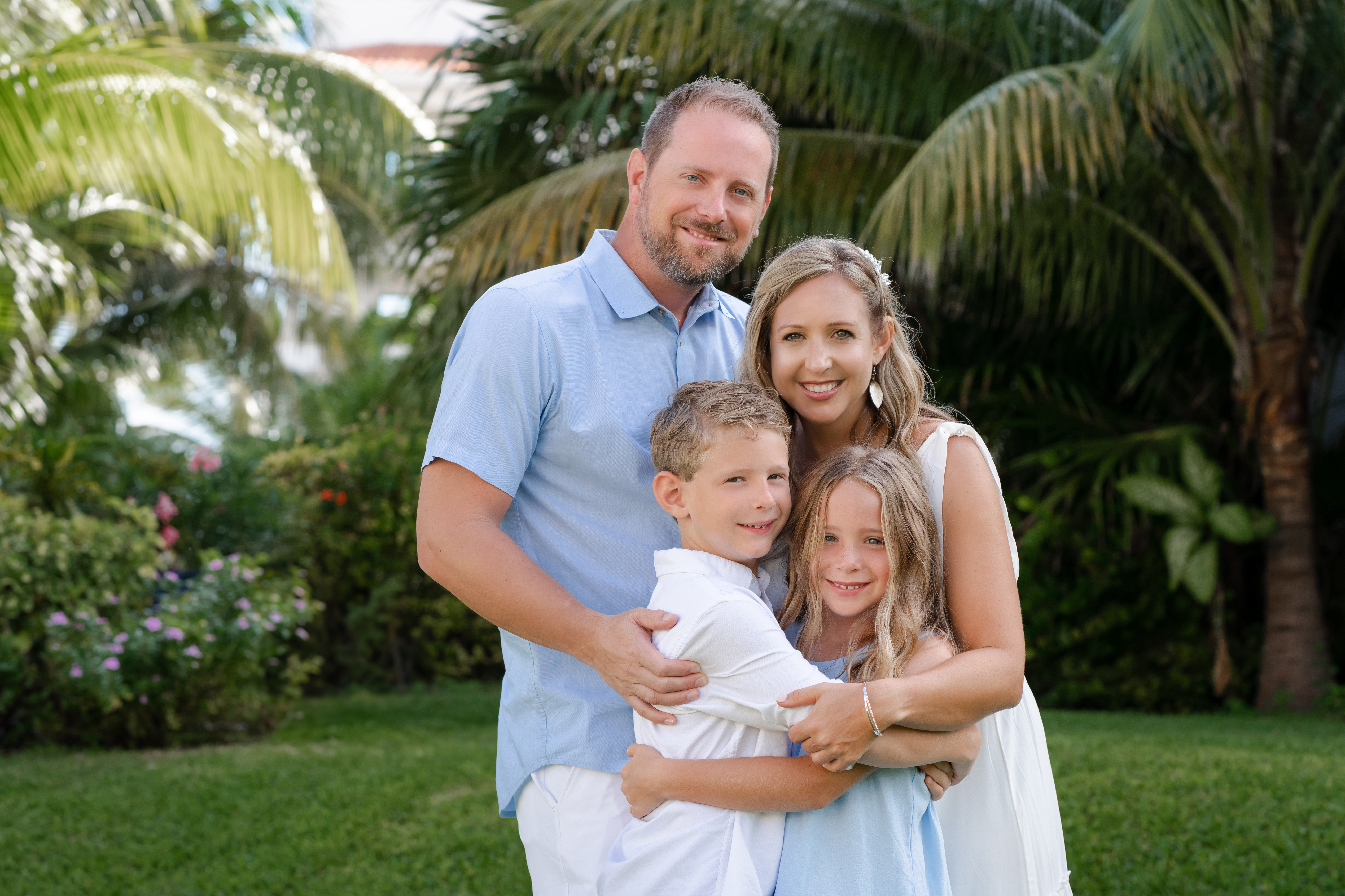 Family photo session on white sand beach in Cancun