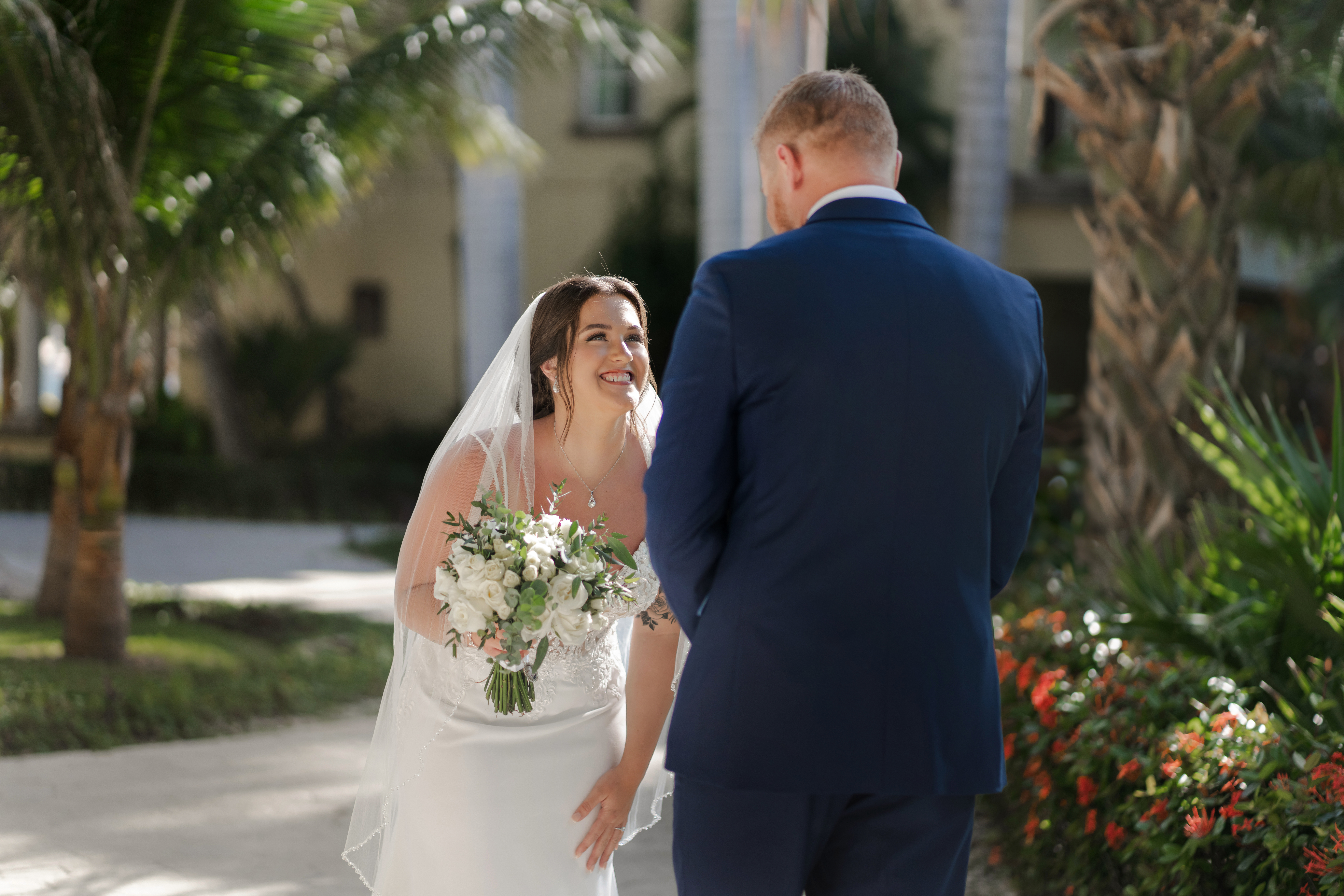 Bride and groom first look at luxury resort garden